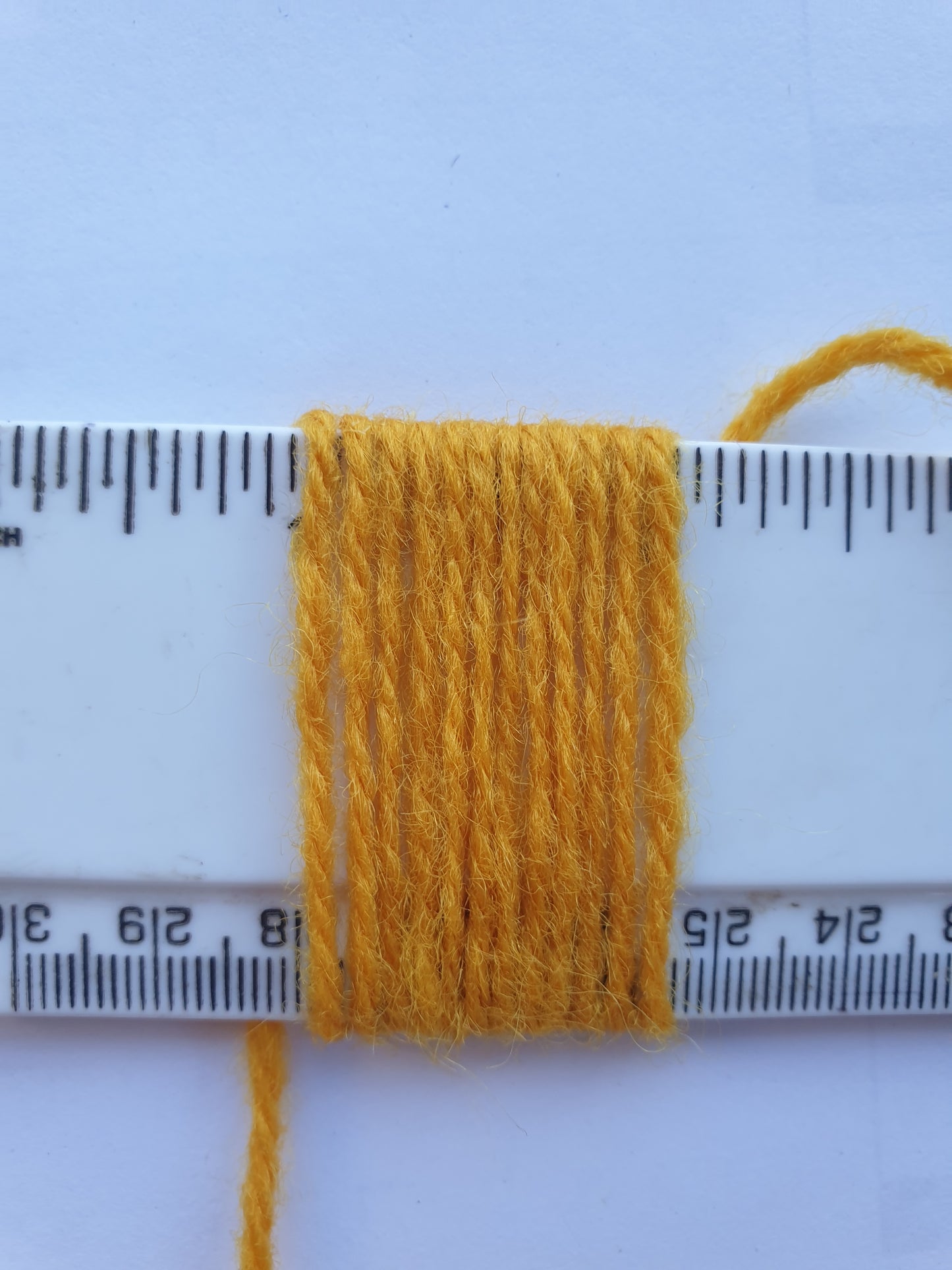 Corn Yellow Rug Yarn showing wraps per inch