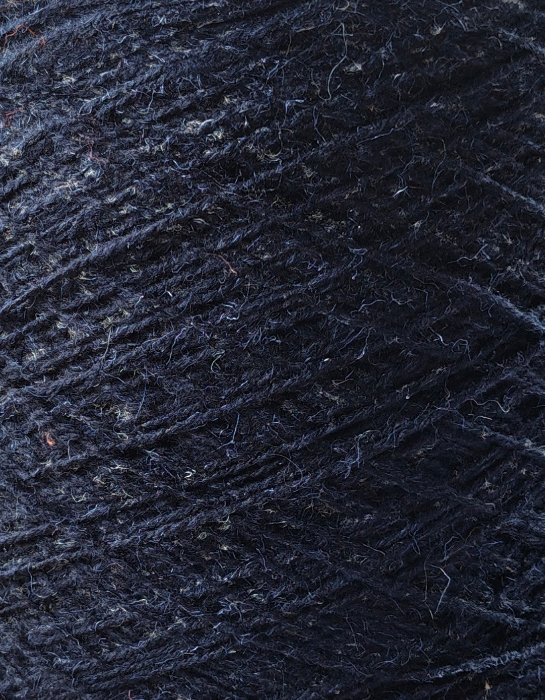 Close-up of dark blue yarn with visible texture