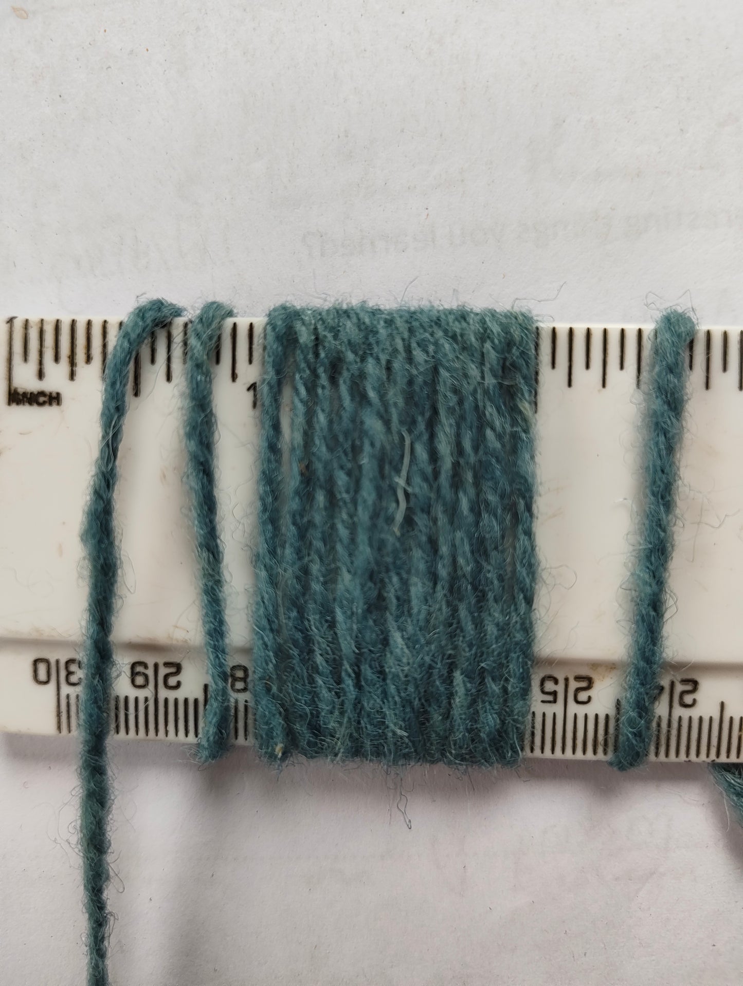 Light sky blue rug yarn showing 11 wraps per inch