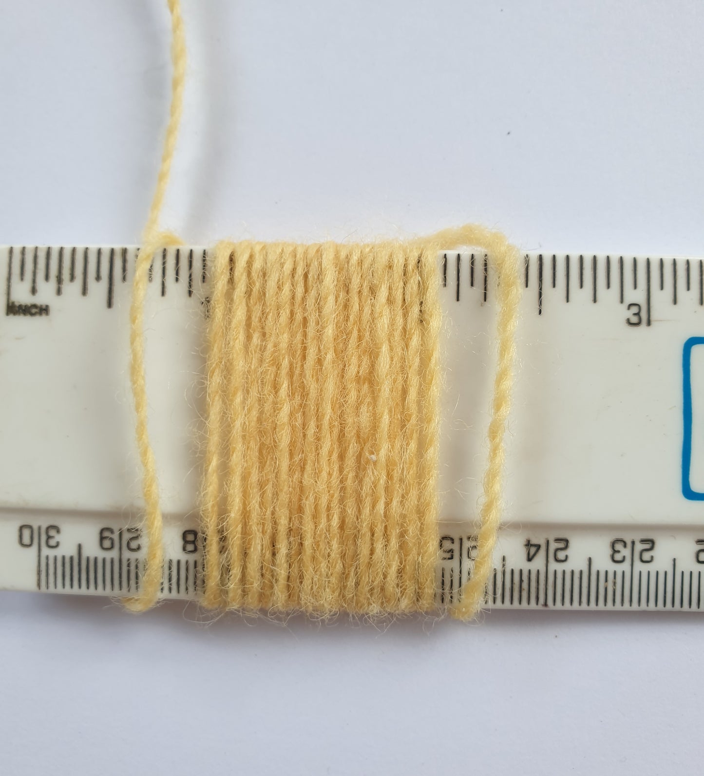 Custard yarn showing wraps per inch