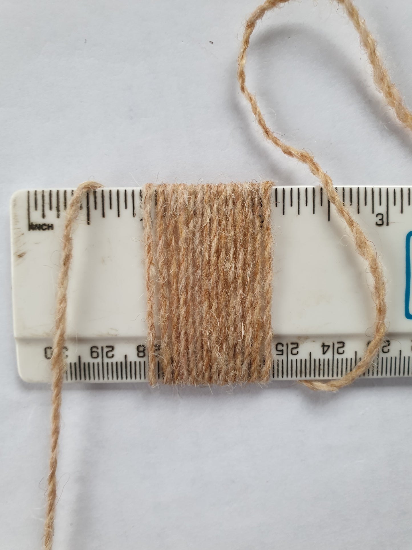 Thin fawn rug yarn showing 14 wpi