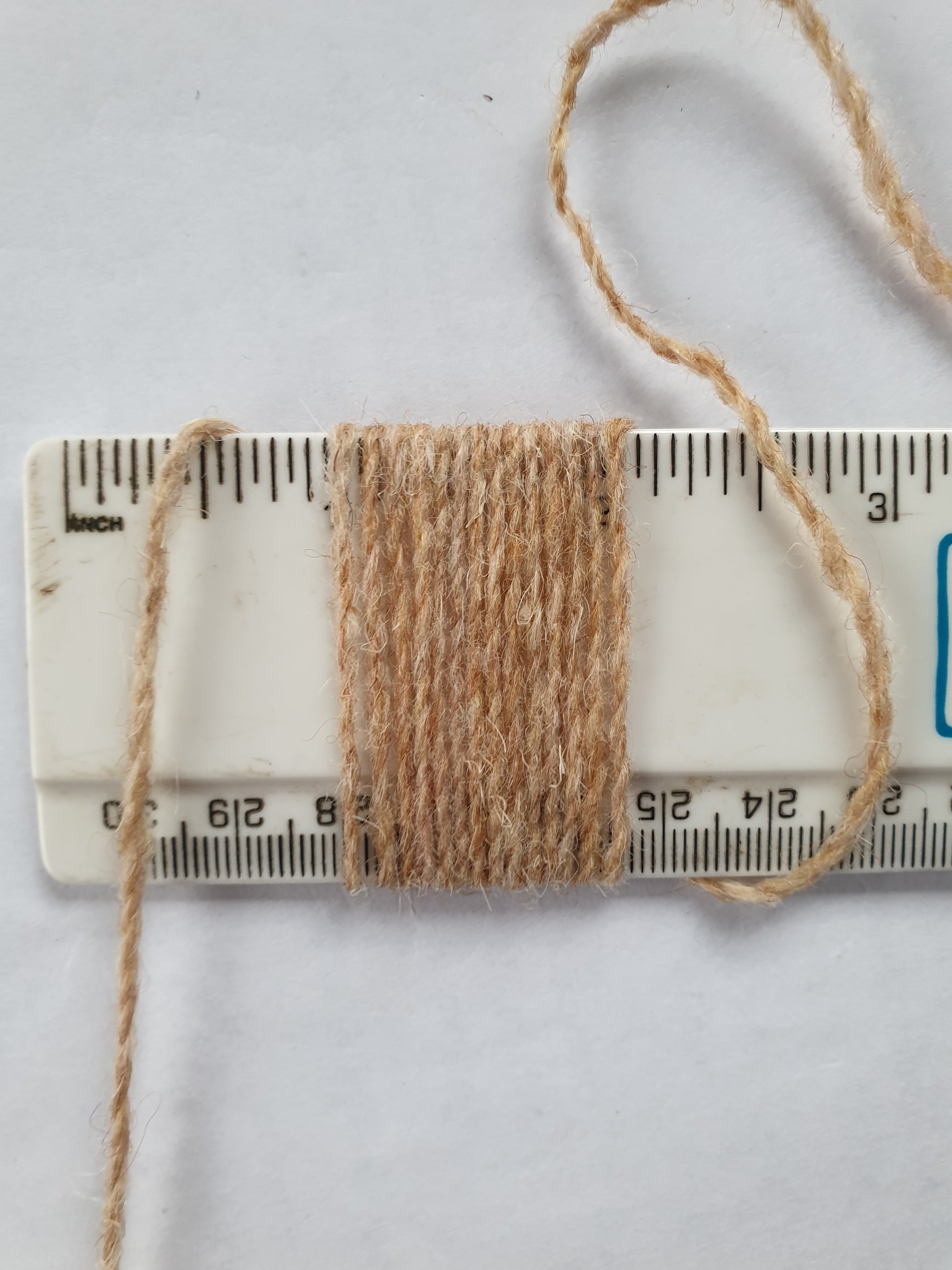 Thin fawn rug yarn showing 14 wpi