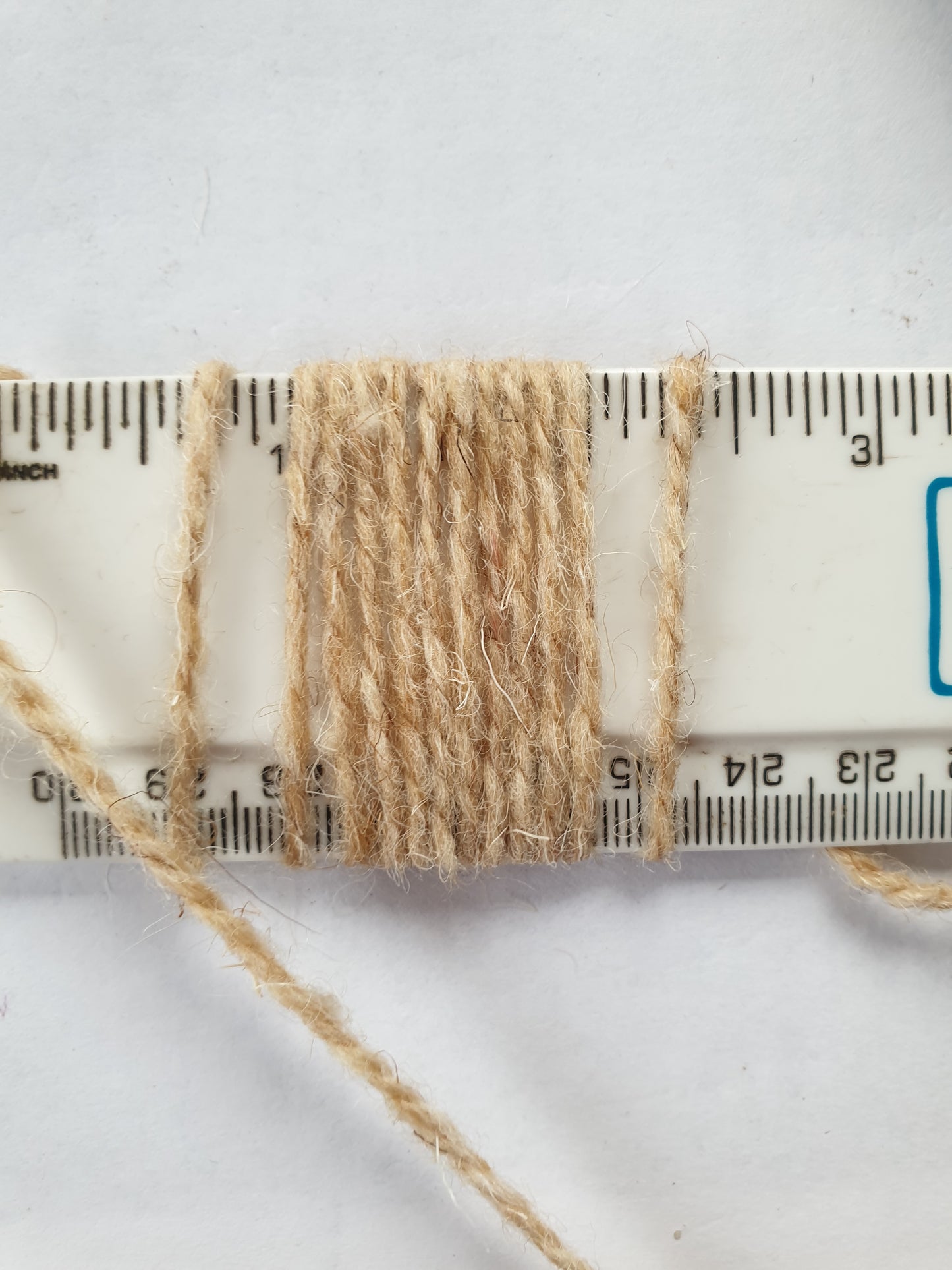 Pale fawn rug yarn showing 10 wpi