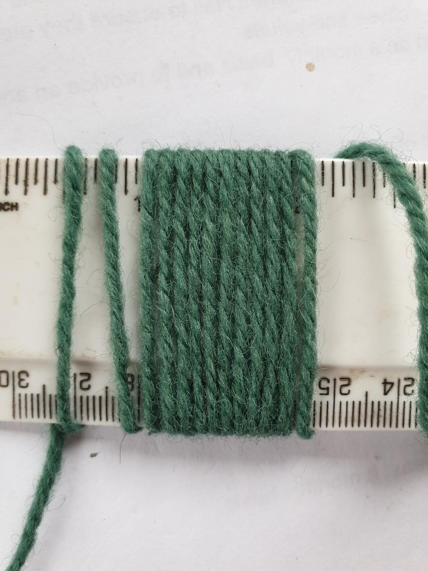 A pastel green medium trhickness rug yarn showing 11wpi