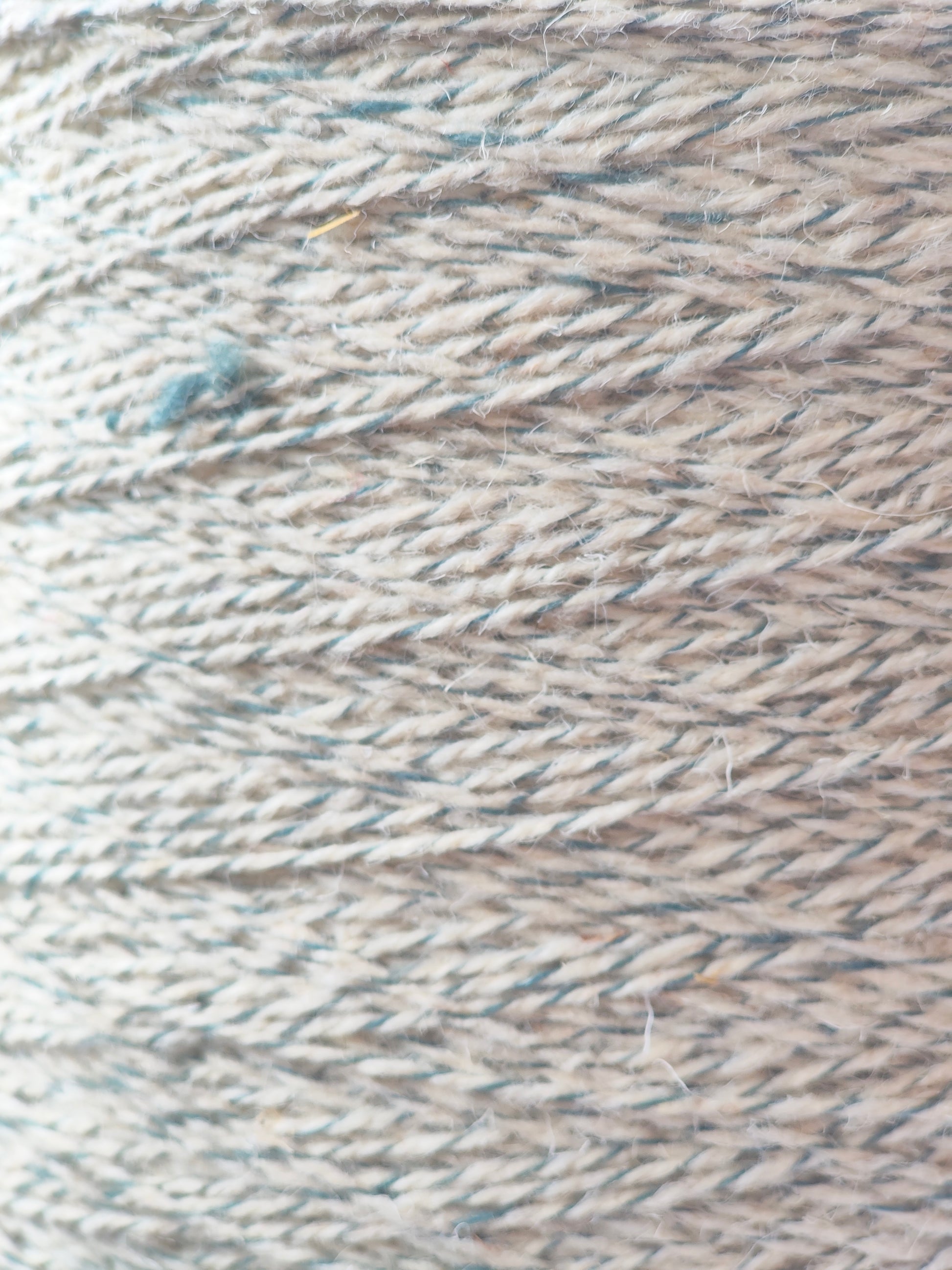A close up of blue grey twist rug yarn