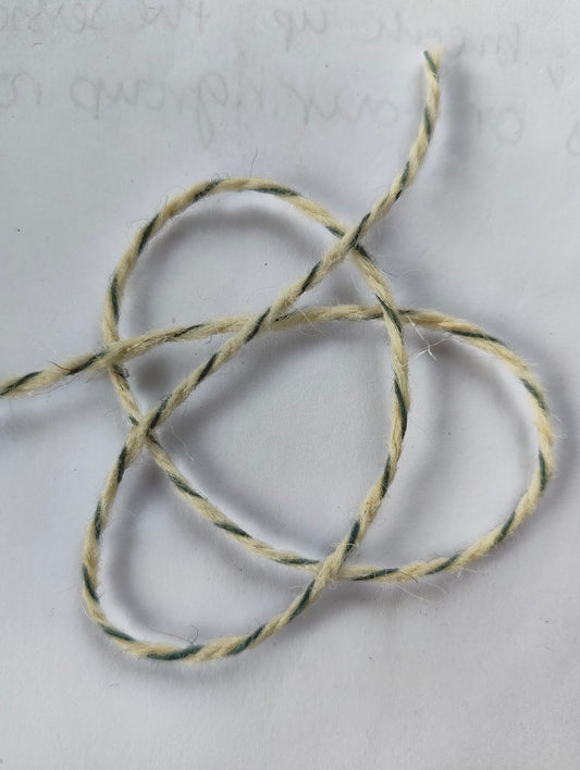 A short length f grey blue twist rug yarn showing the twist detail