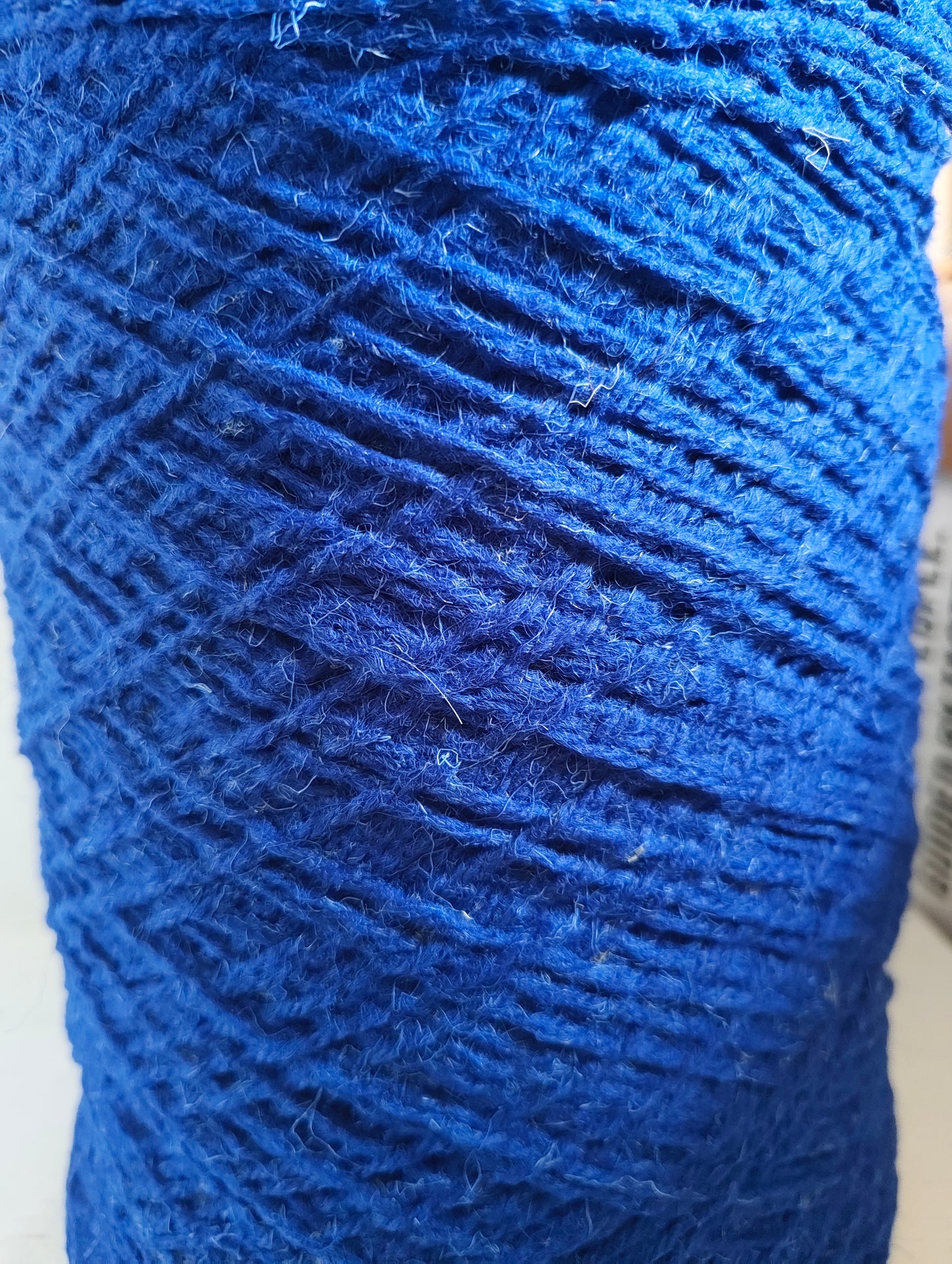 A close-up of cobalt blue weaving yarn