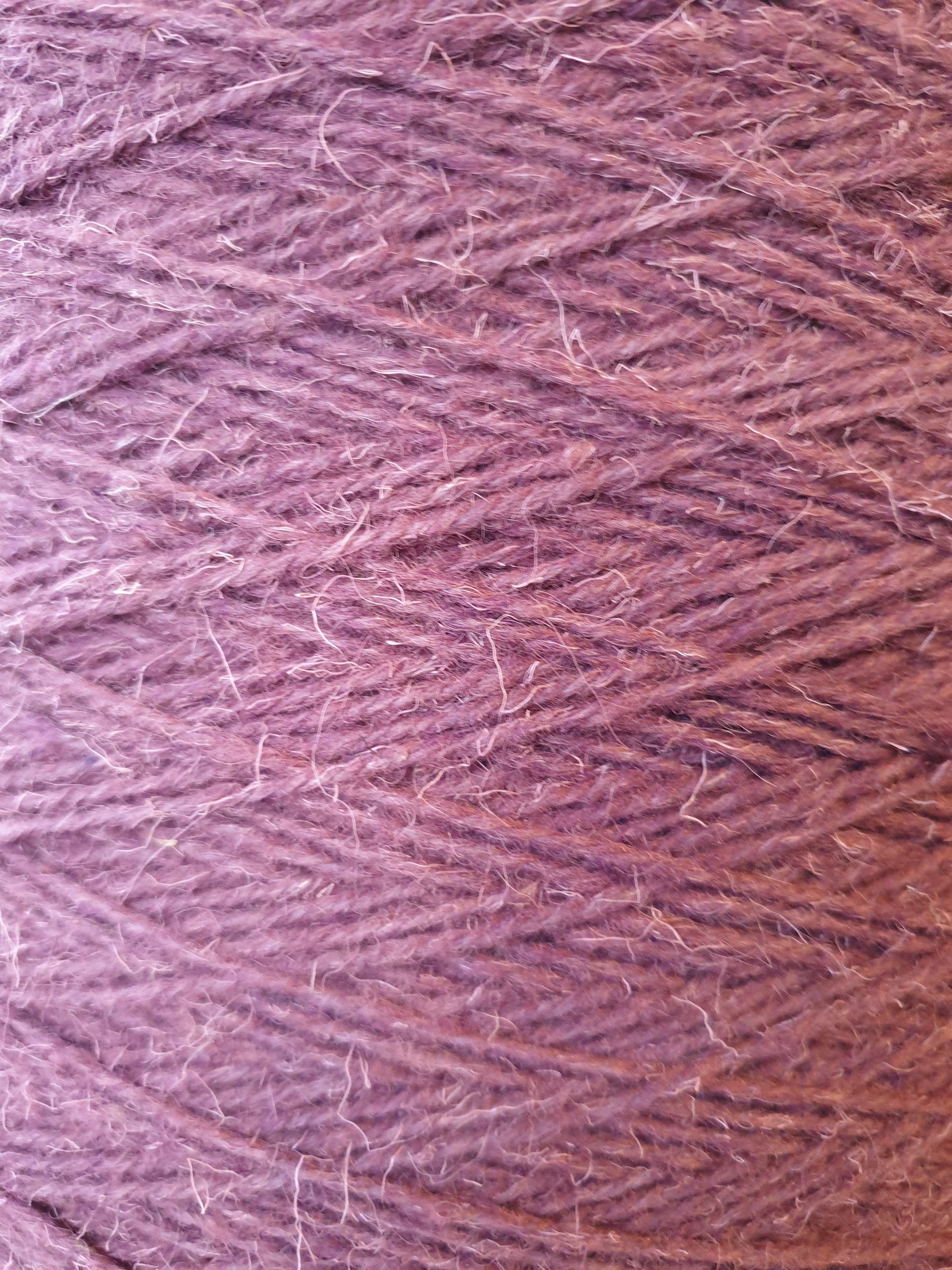 Detail of mauve rug wool under a bright light