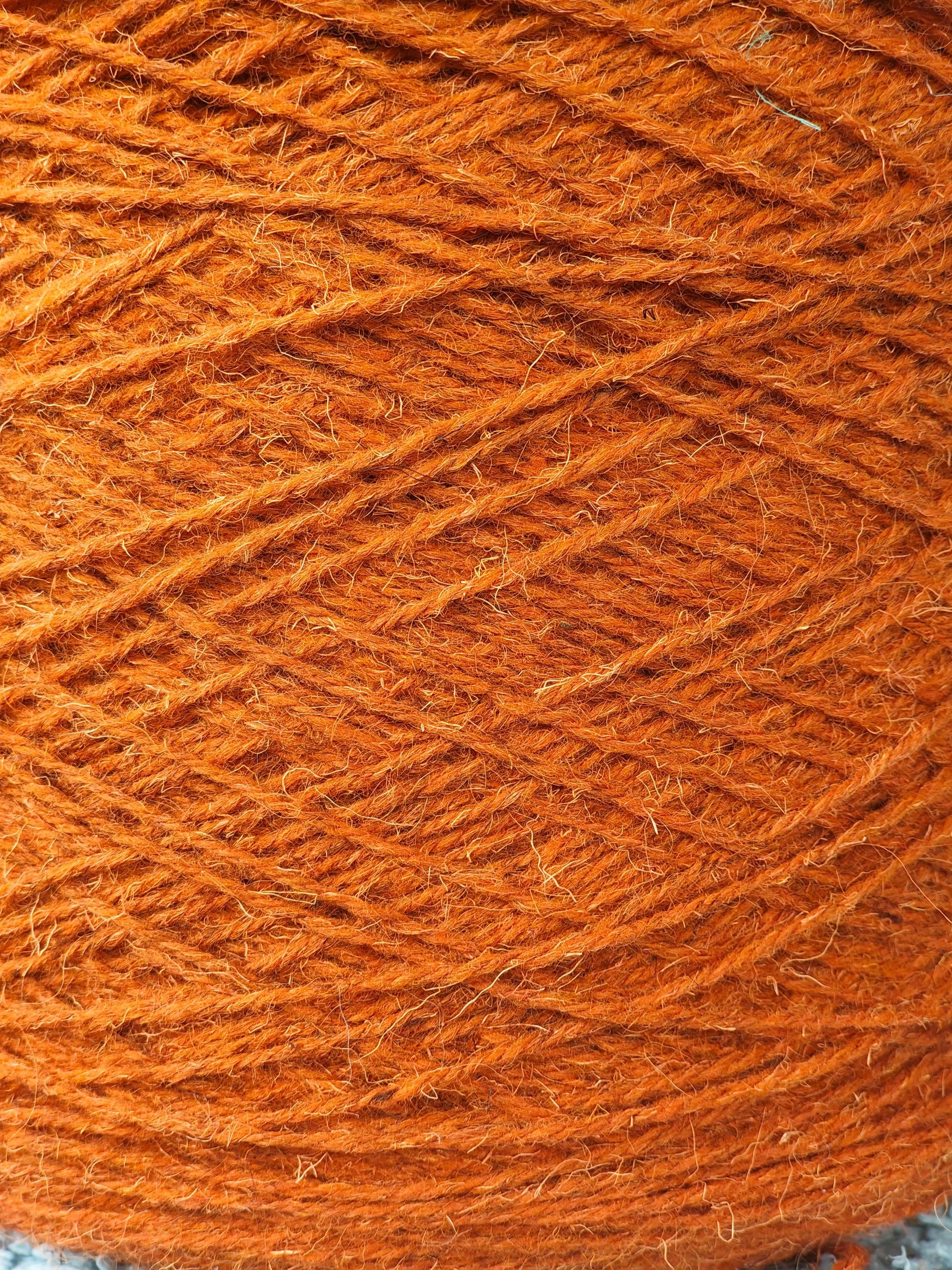 Close-up of a rust-coloured rug yarn