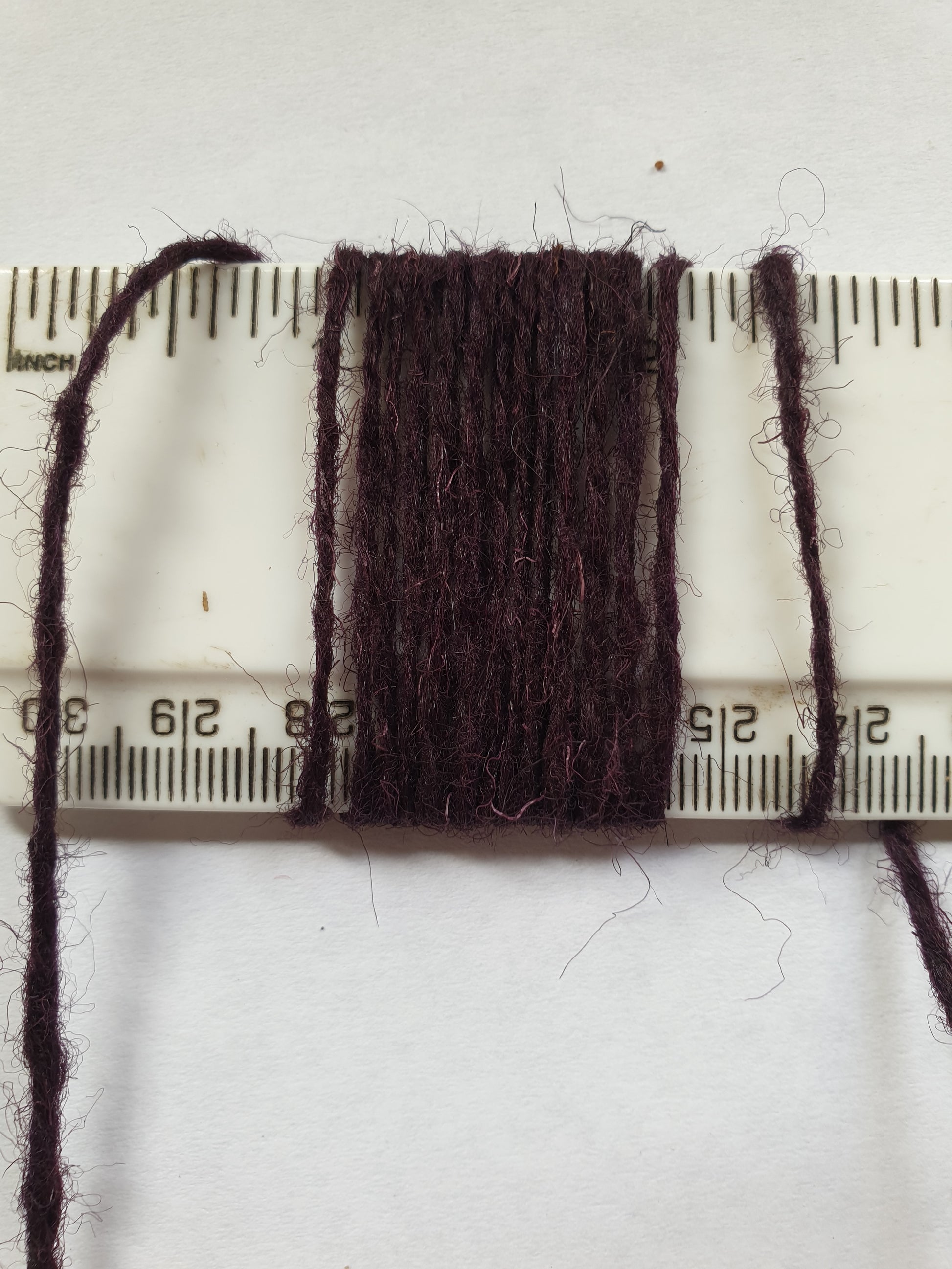 Dark purple rug yarn showing wpi