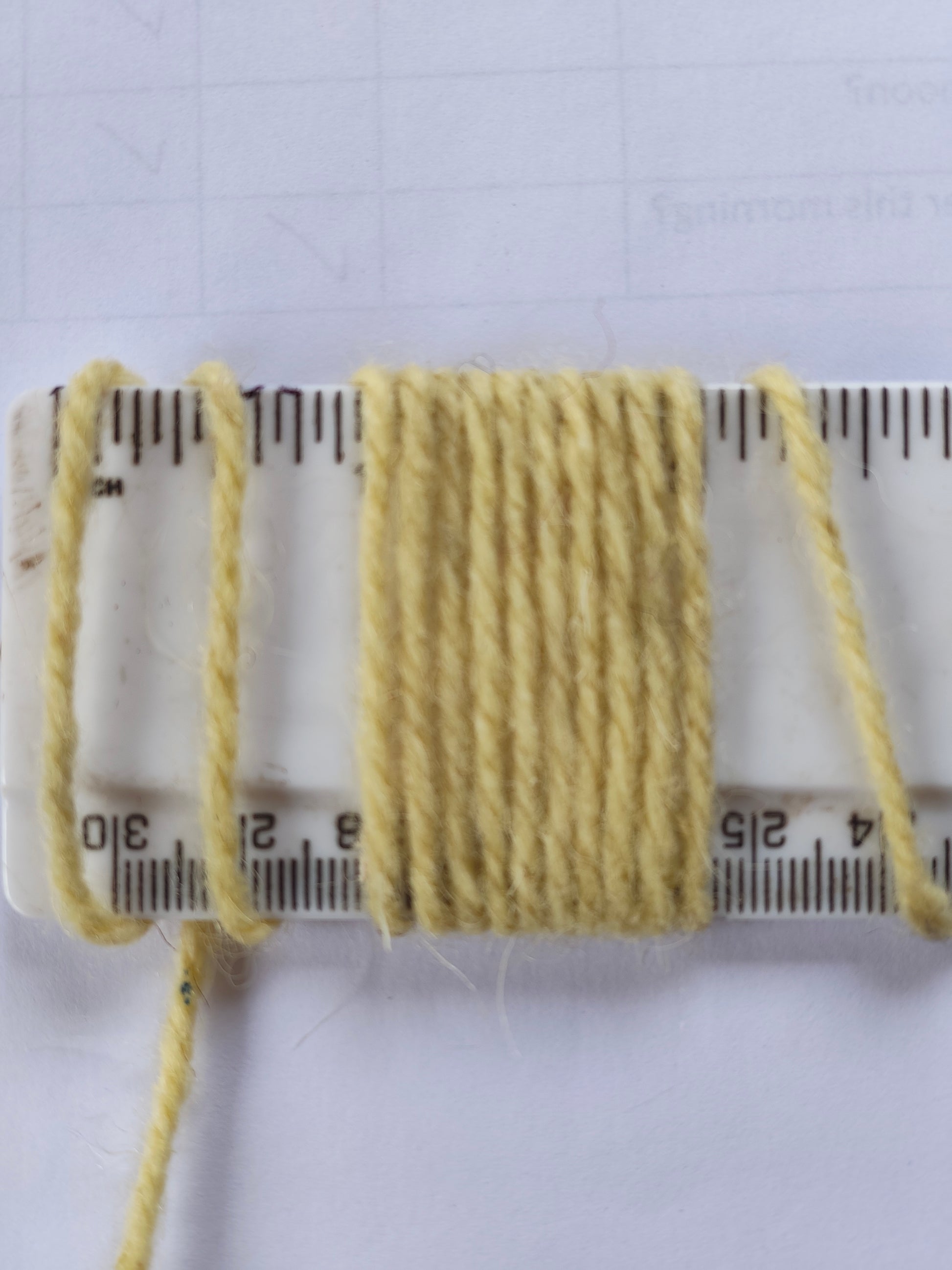 Yellow carpet yarn showing wraps per inch