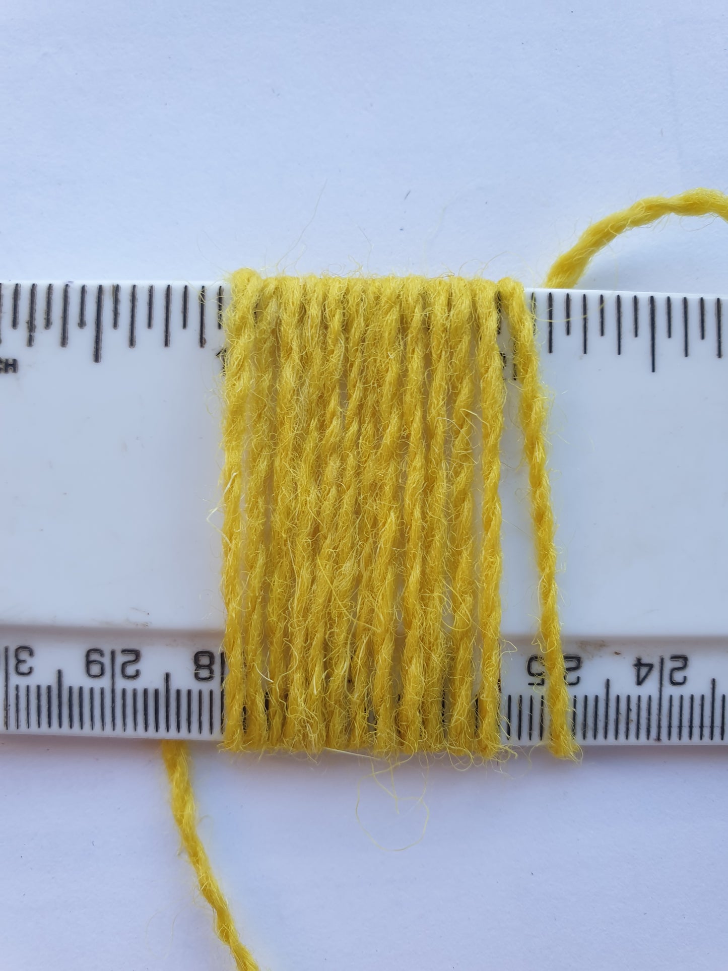 Acid Yellow Rug Yarn showing wraps per inch