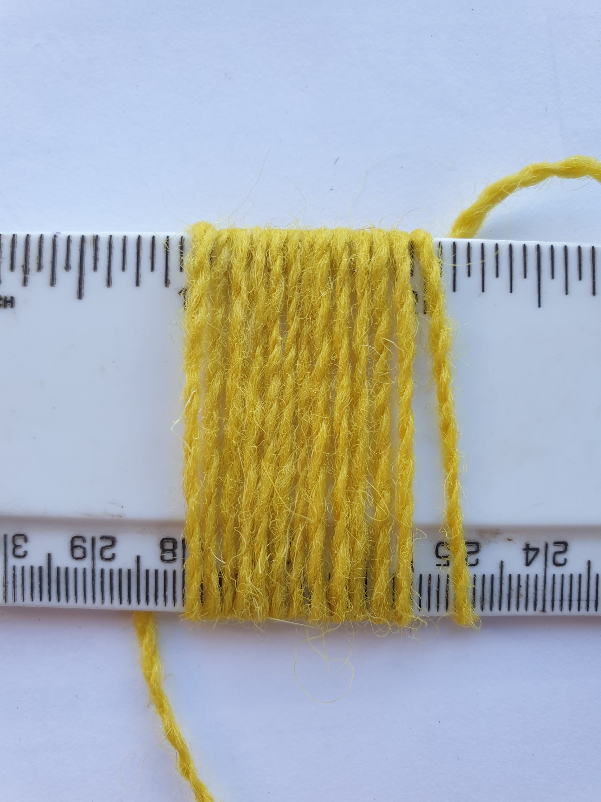 Acid Yellow Rug Yarn showing wraps per inch