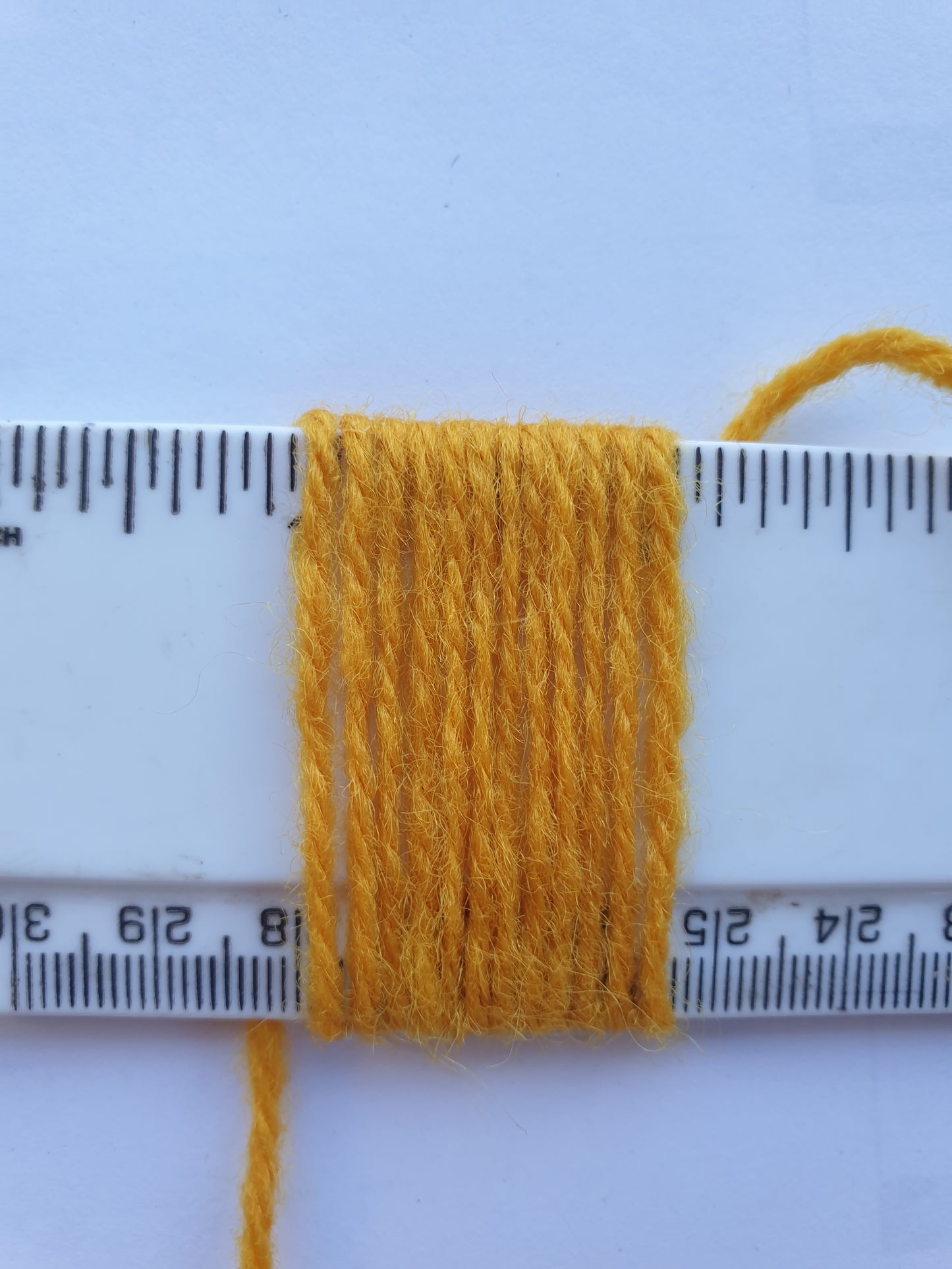 Corn Yellow Rug Yarn showing wraps per inch