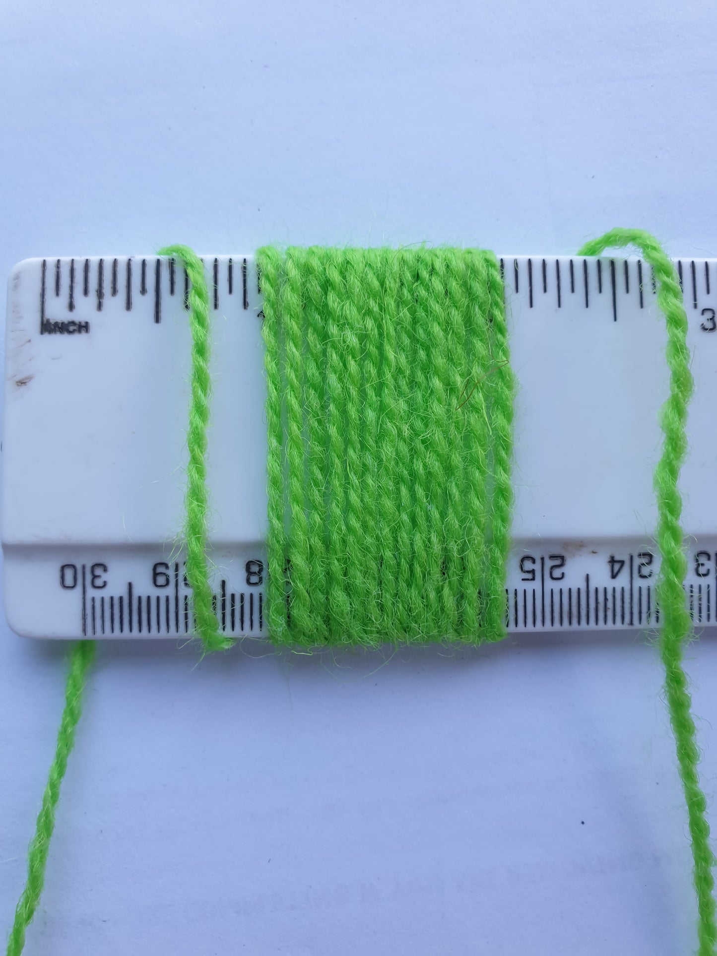 Lime Green Rug Yarn showing wraps per inch