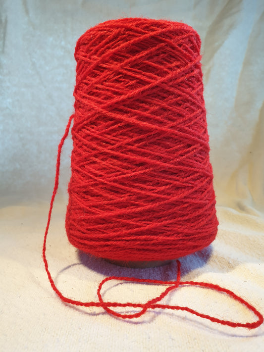 A cone of Red Rug Yarn