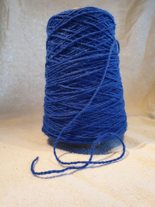 A cone of Royal Blue Rug Yarn