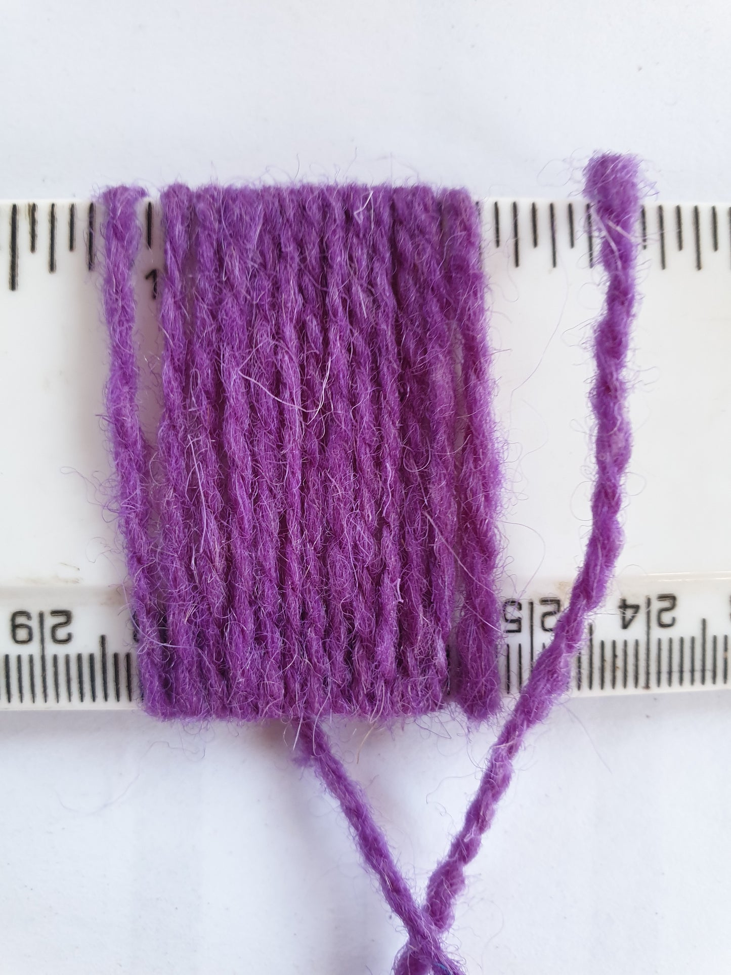 Purple Rug Yarn showing wraps per inch