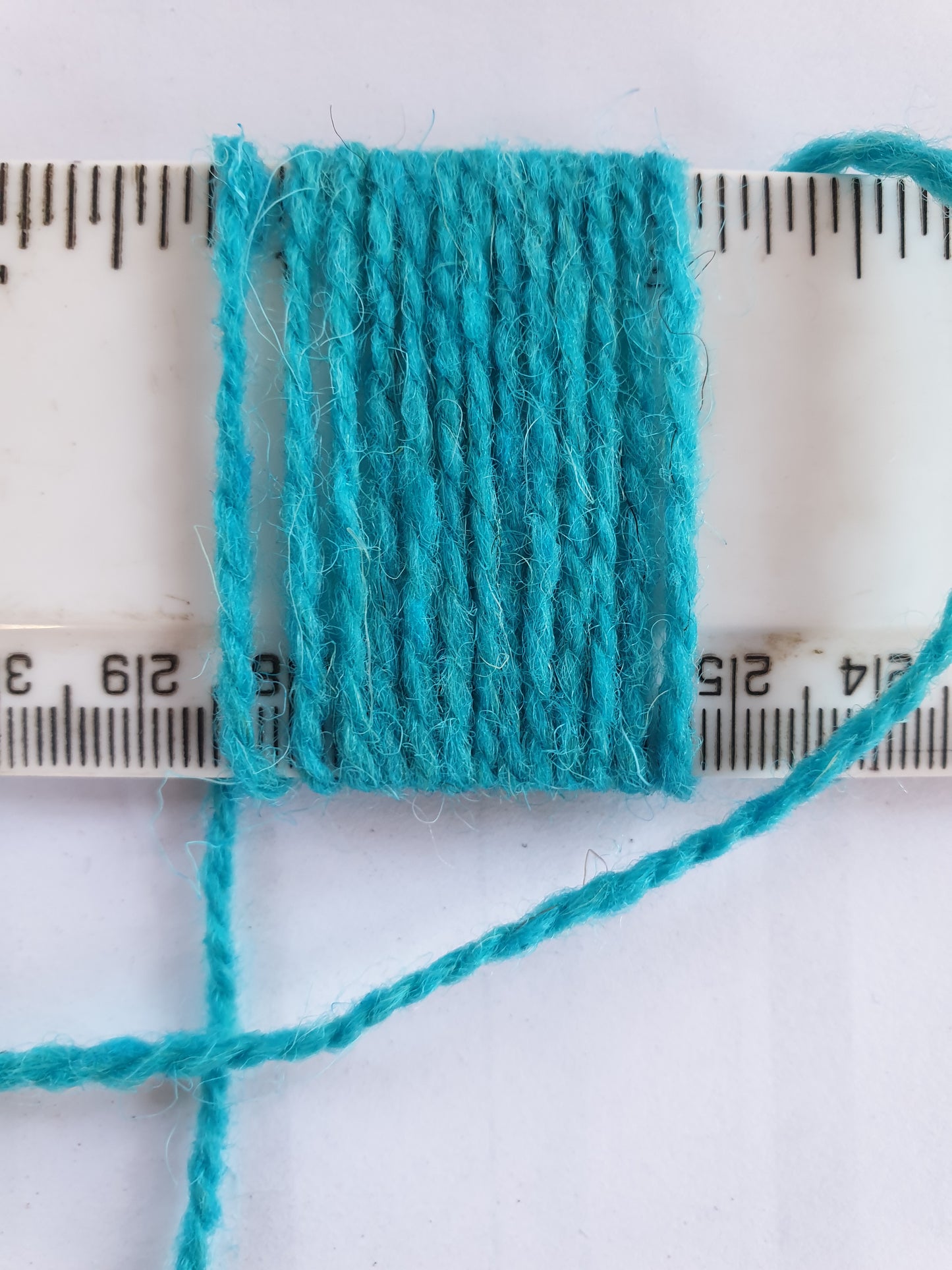 Light Blue Rug Yarn showing wraps per inch