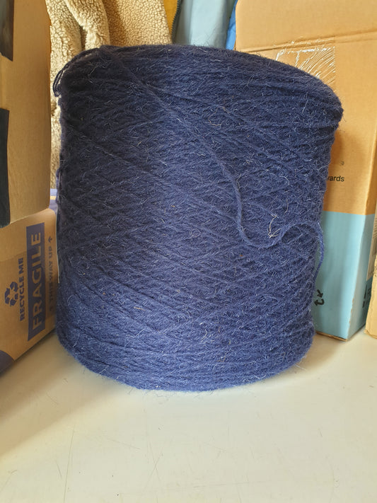 A large cone of rug wool the colour of a blue biro