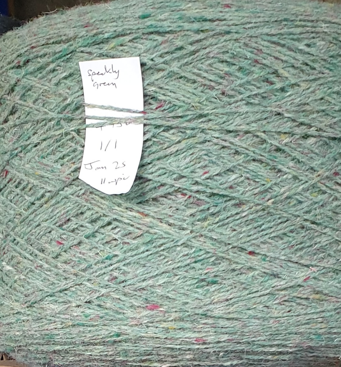 Speckley green rug yarn with purple flecks