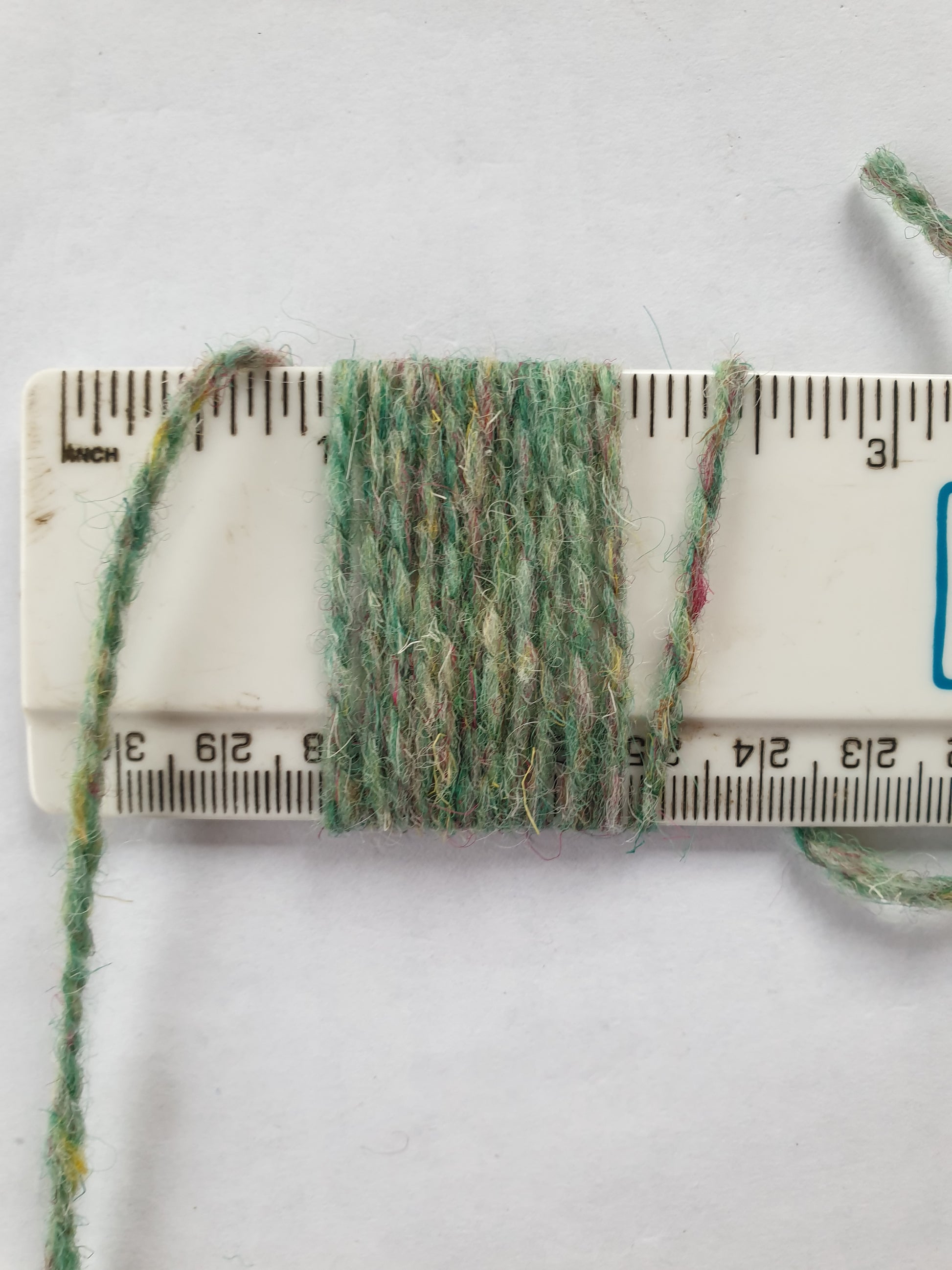 Speckley green rug yarn showing 11 wpi