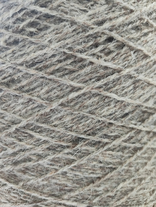 A close-up of tweedy grey rug yarn with a heathered blend of grey fibres.