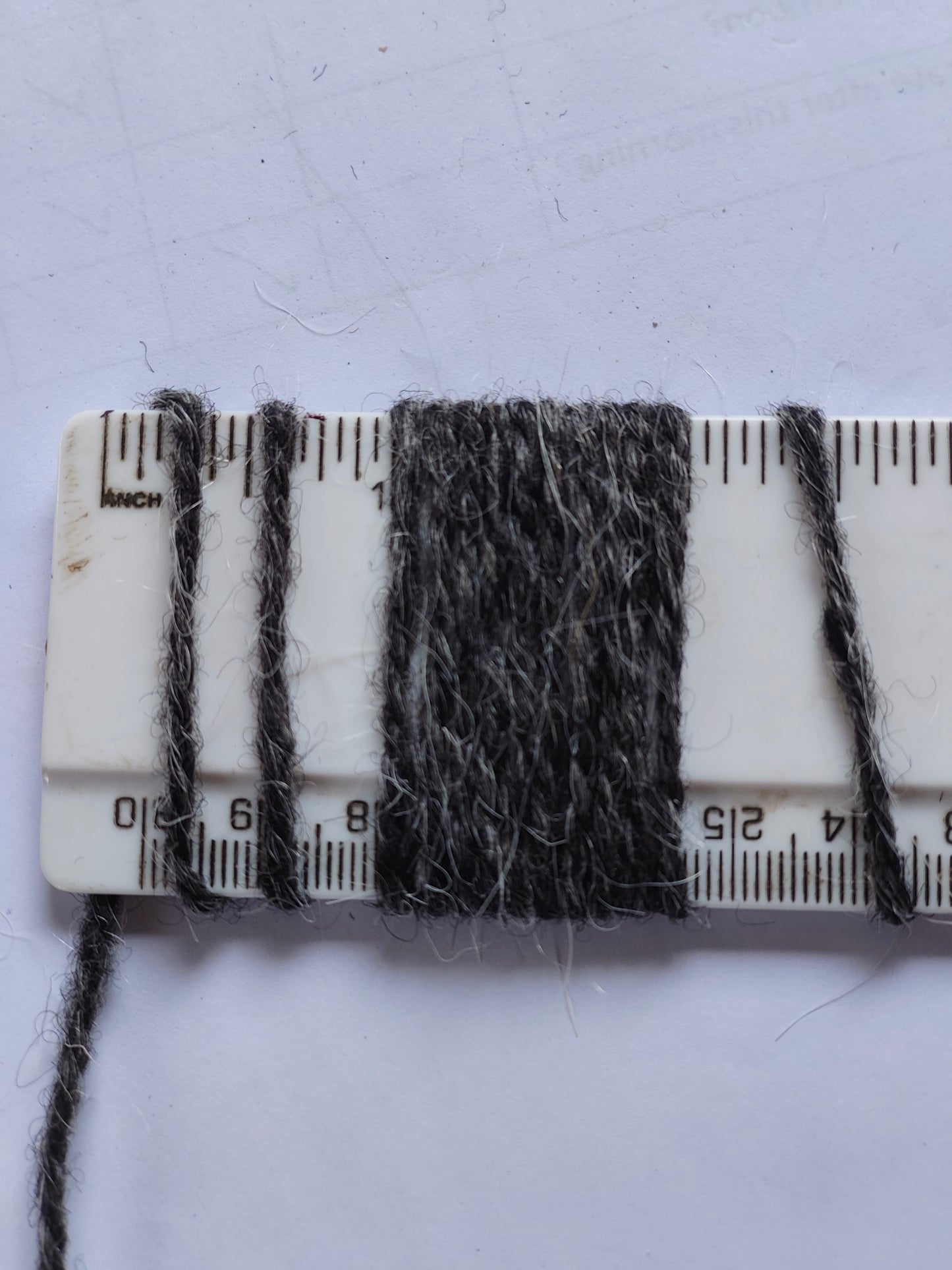 shaggy dar grey rug yarn showing 10 wraps per inch