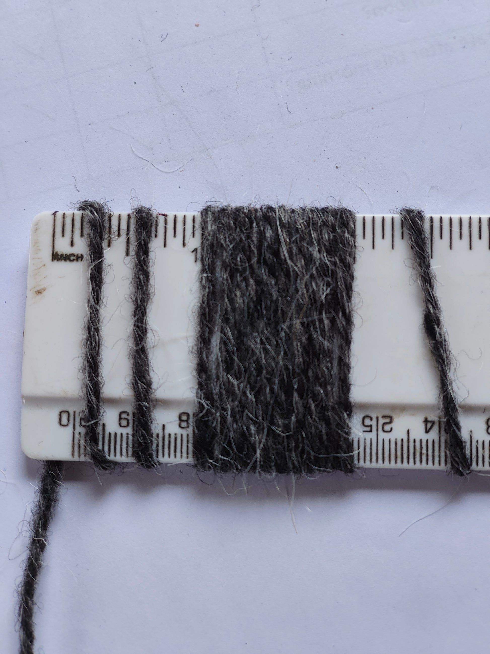 shaggy dar grey rug yarn showing 10 wraps per inch