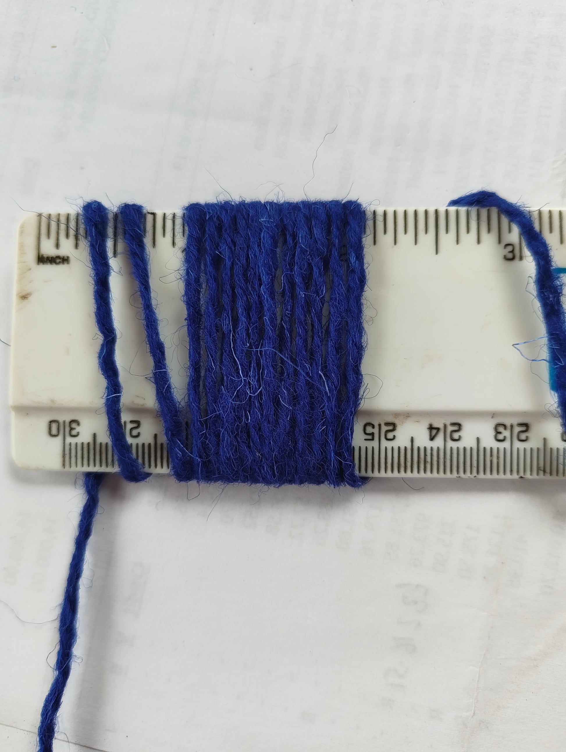 Cobalt Blue rug yarn showing 11 wraps per inch