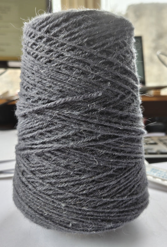 A cone of bluey grey rug yarn for weaving, tufting etc