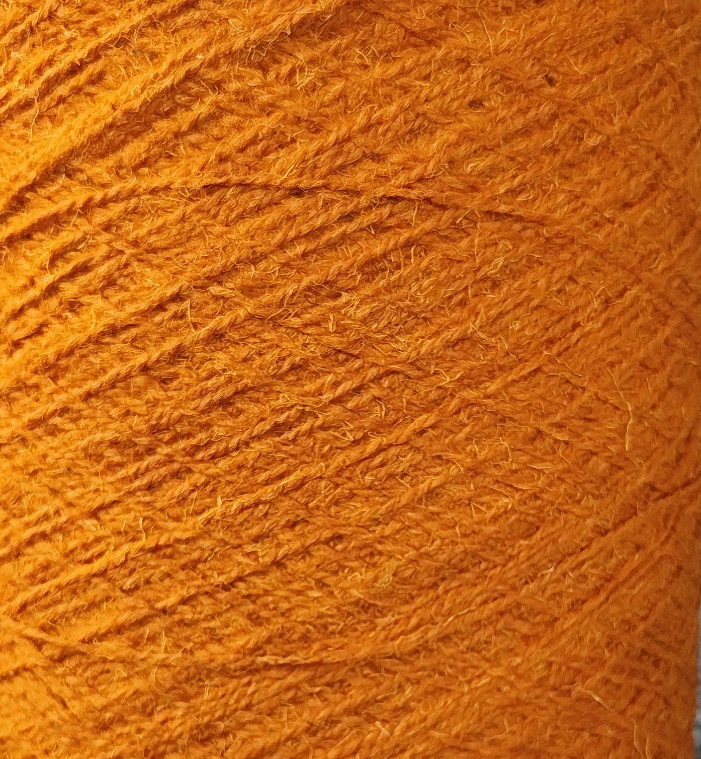 A detail of golden orange rug yarn