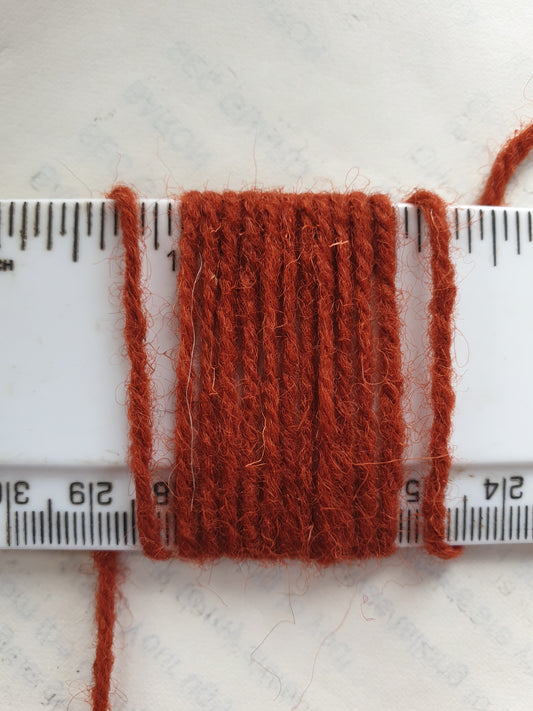 Orangey brown yarn for rugs etc showing wraps per inch