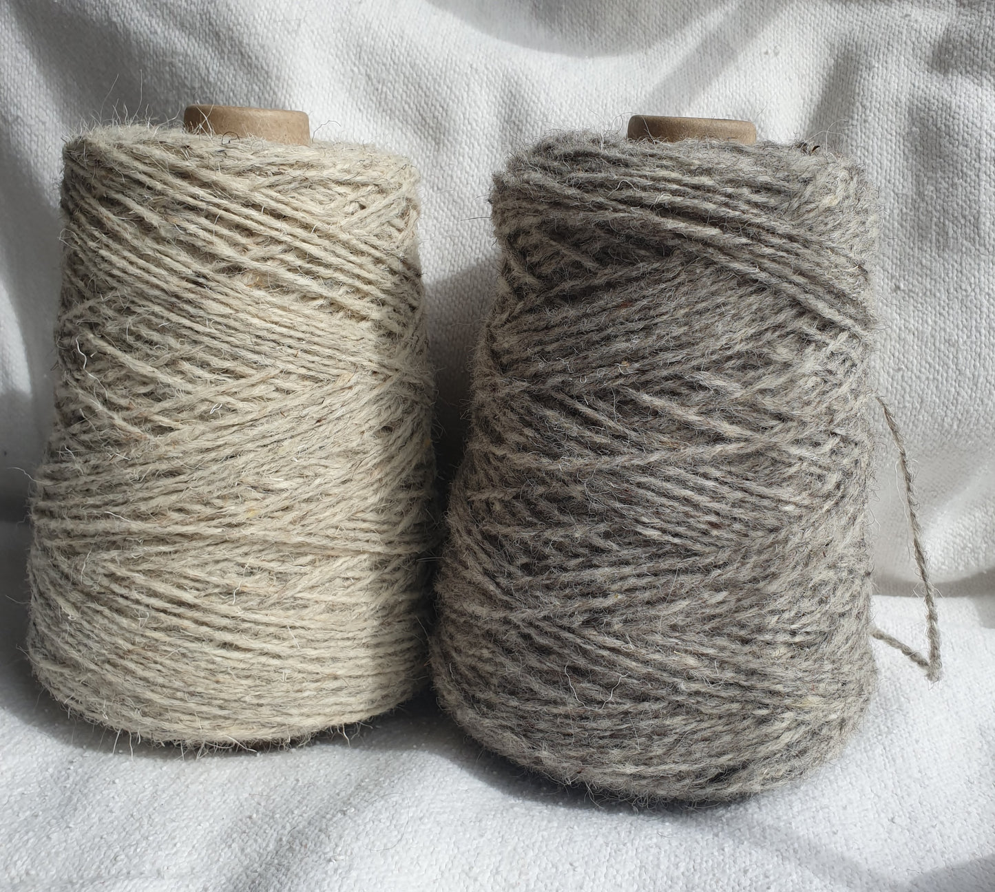 2 different grey cones of rug yarn