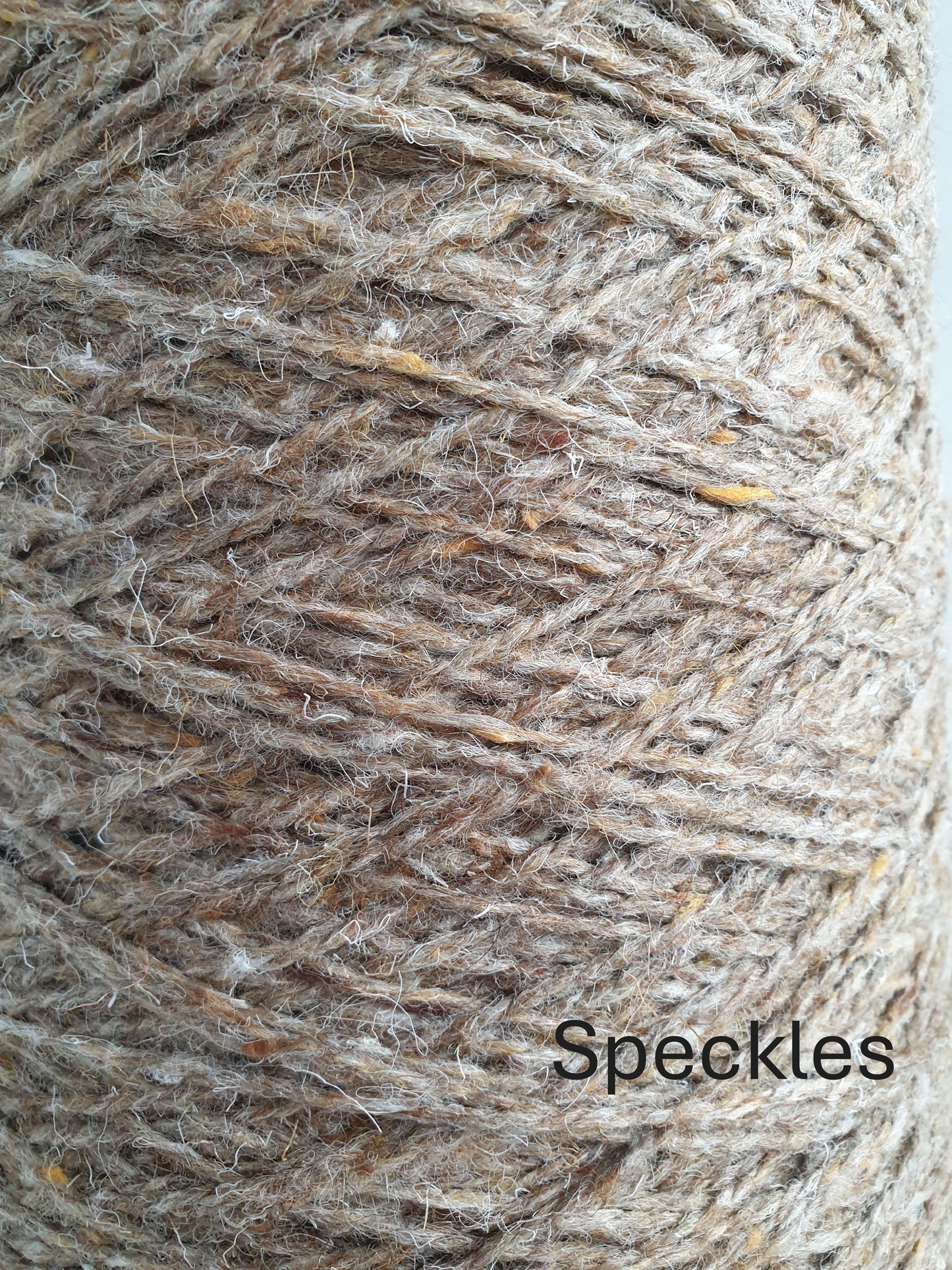 Close up of fawn tweed speckley rug yarn